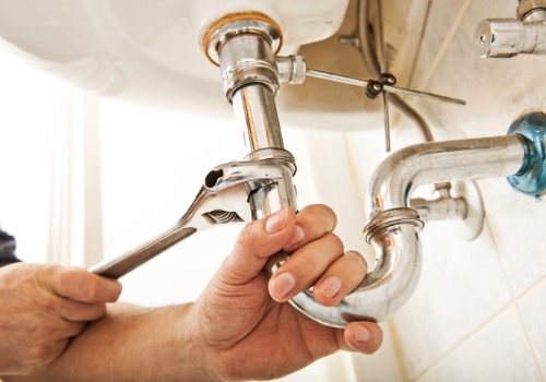 A plumber repairing a sink during Residential Plumbing in Peoria IL