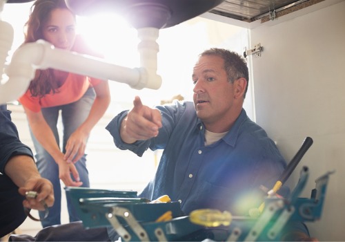 A 24-Hour Plumber in East Peoria IL pointing out a leak to a homeowner