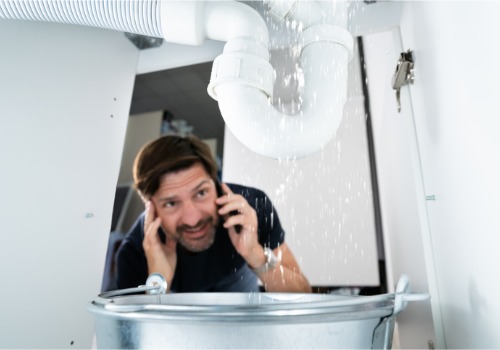 A man looking at a leak, calling a 24-Hour Plumber in East Peoria IL