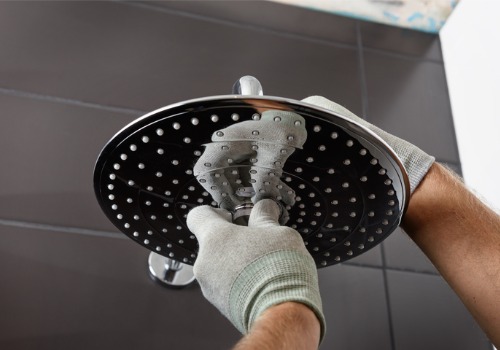 A plumber installing a new shower fixture as a part of Bathroom Plumbing in Peoria IL